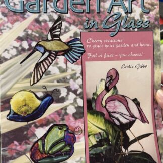 Book cover for Garden Art in Glass showing colorful glass garden sculptures (hummingbird, frog, snail, flamingo) against a floral background.