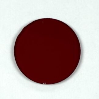 Close-up of a dark red circular drop on a white background on surface.