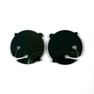 Pair of small black circular objects with tiny ear-like bumps on top and a curved notch, lying side by side on a white background.