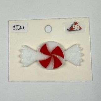 Enamel pin shaped like a red-and-white peppermint candy on a white card.