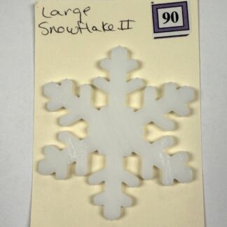 Large white snowflake cutout mounted on a pale yellow card, with handwritten label 'Large Snowflake II' and a purple-stamped '90' in the corner.