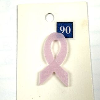 Pink awareness ribbon pin attached to a white display card with a small blue square showing the number 90 (breast cancer awareness).